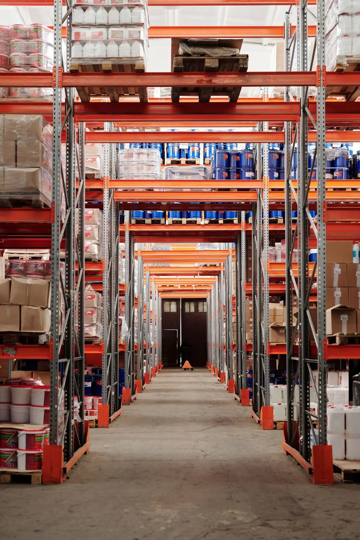 Sunlit rows of stacked cartons in a warehouse